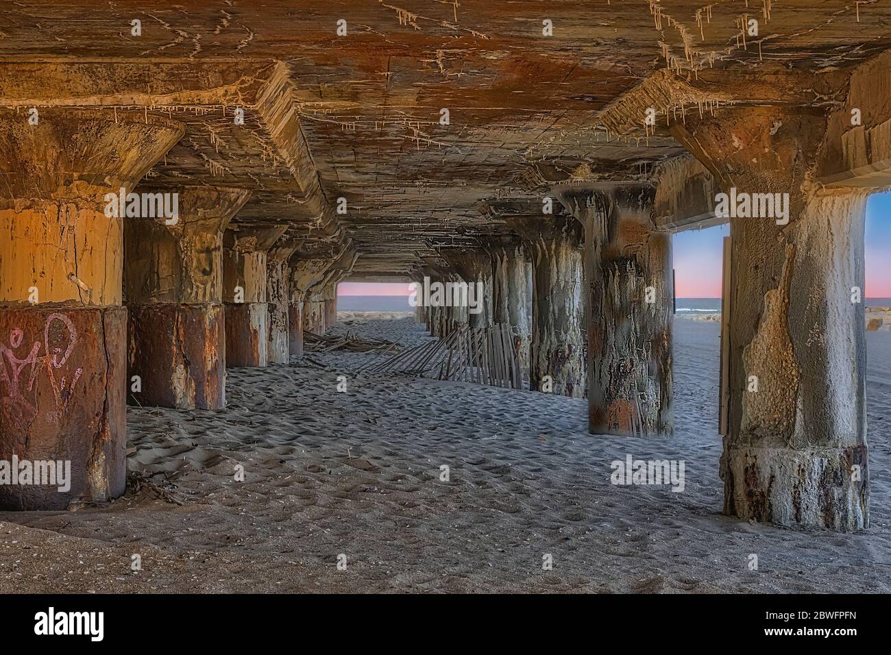 Asbury Park Pilings - una vista da sotto la Sala Congressi di Asbury Park con le palazzine in acciaio racchiusi nella spiaggia di Asbury Park nel New Jersey. Foto Stock