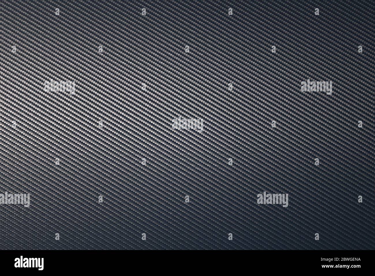 Primo piano della superficie in lamiera di carbonio grigia con orientamento diagonale. Texture e pattern di sfondo. Tecnologia moderna e concetto di materiale. Foto Stock