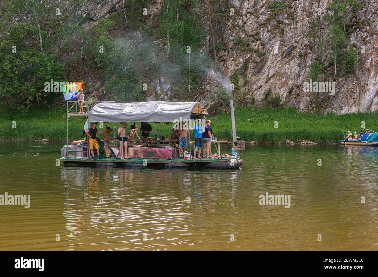 La gente si rilassa su una zattera primitiva durante un rafting sul fiume. Turisti rafting, galleggianti. Russia, Bashkortostan, luglio 2019 Foto Stock