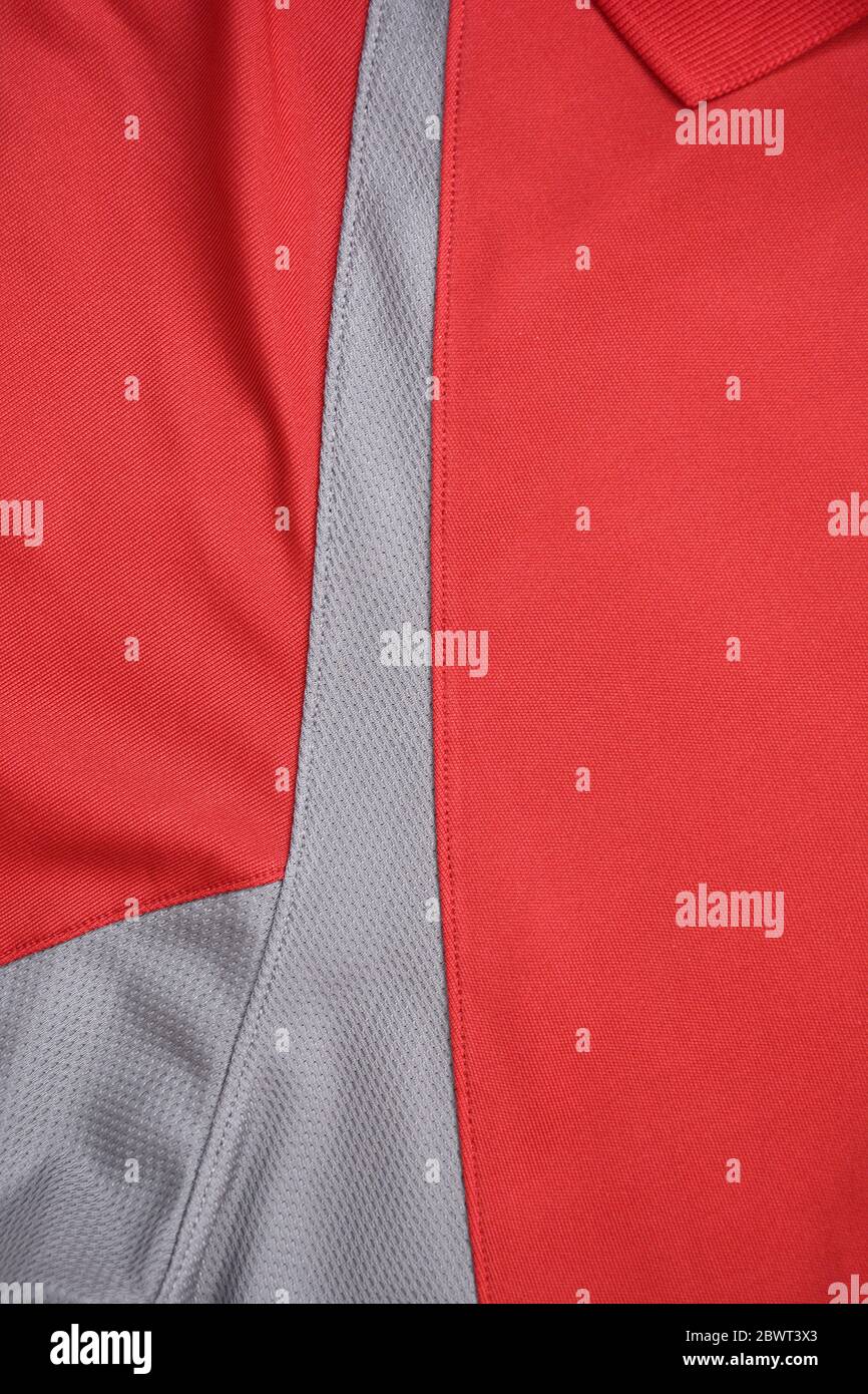 Tessuto in Jersey rosso e grigio, sfondo sportivo. Foto Stock
