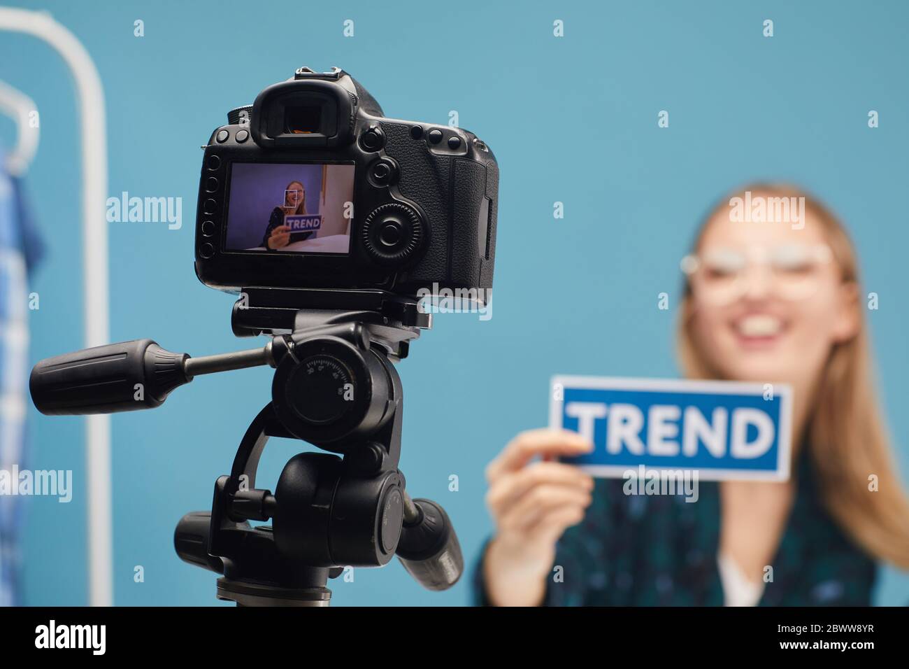 Videocamera sul treppiede con la donna che riprende i contenuti per il suo blog Foto Stock