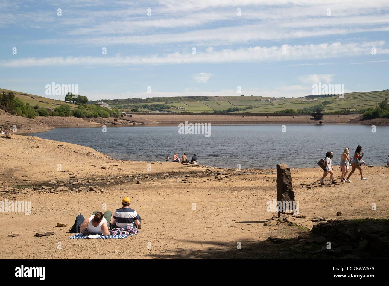 Turisti e residenti godono di sole estivo ai margini del Digley Reservoir, nel West Yorkshire, sotto il cielo blu Foto Stock