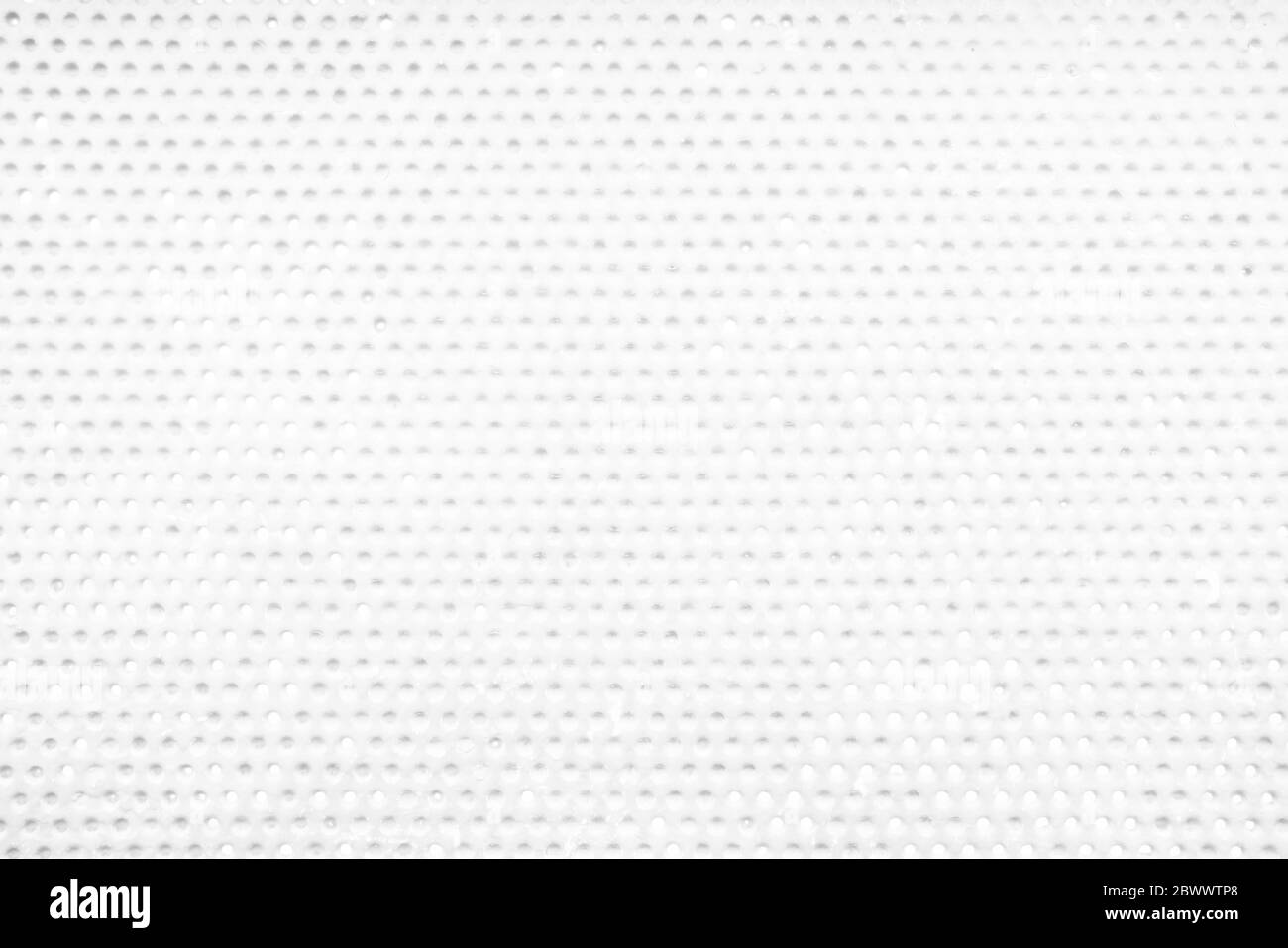Sfondo con texture a parete perforata con foro bianco. Foto Stock