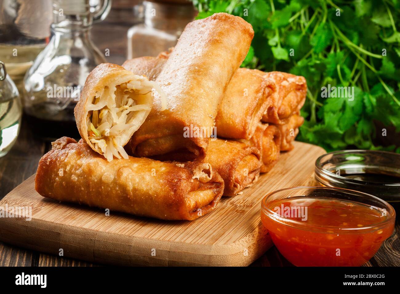 Involtini primavera con pollo e verdure sul tagliere. Cucina asiatica. Foto Stock
