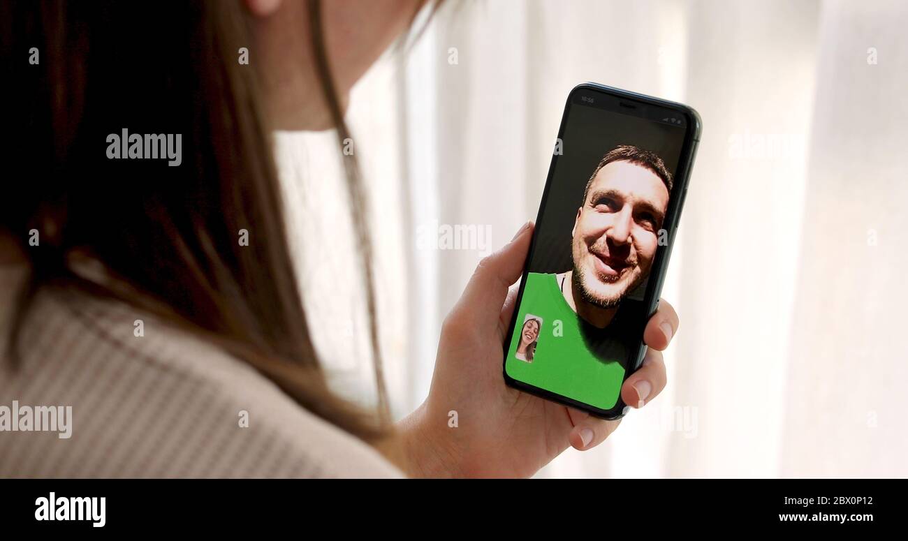 Donna che parla con un uomo con uno smartphone per videochiamata Foto Stock