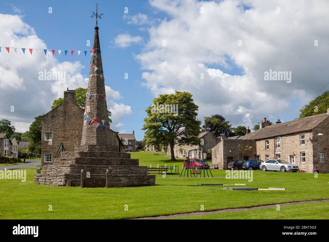Il mercato di pietra sostanziale croce sul verde villaggio in Burton ovest nel Parco Nazionale Yorkshire Dales Foto Stock