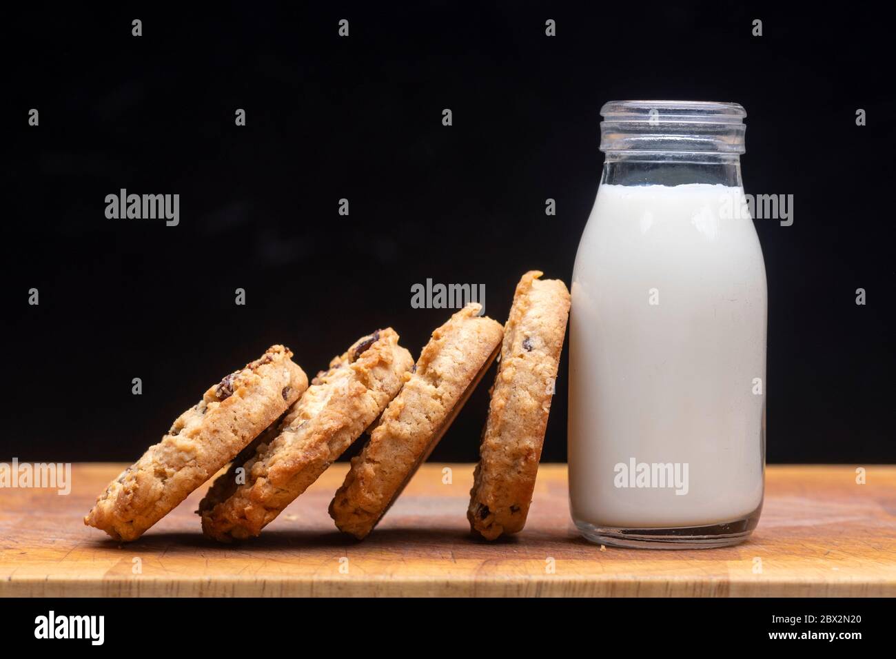 Latte e biscotti, frutta e avena fatti in casa con una bottiglia di latte Foto Stock