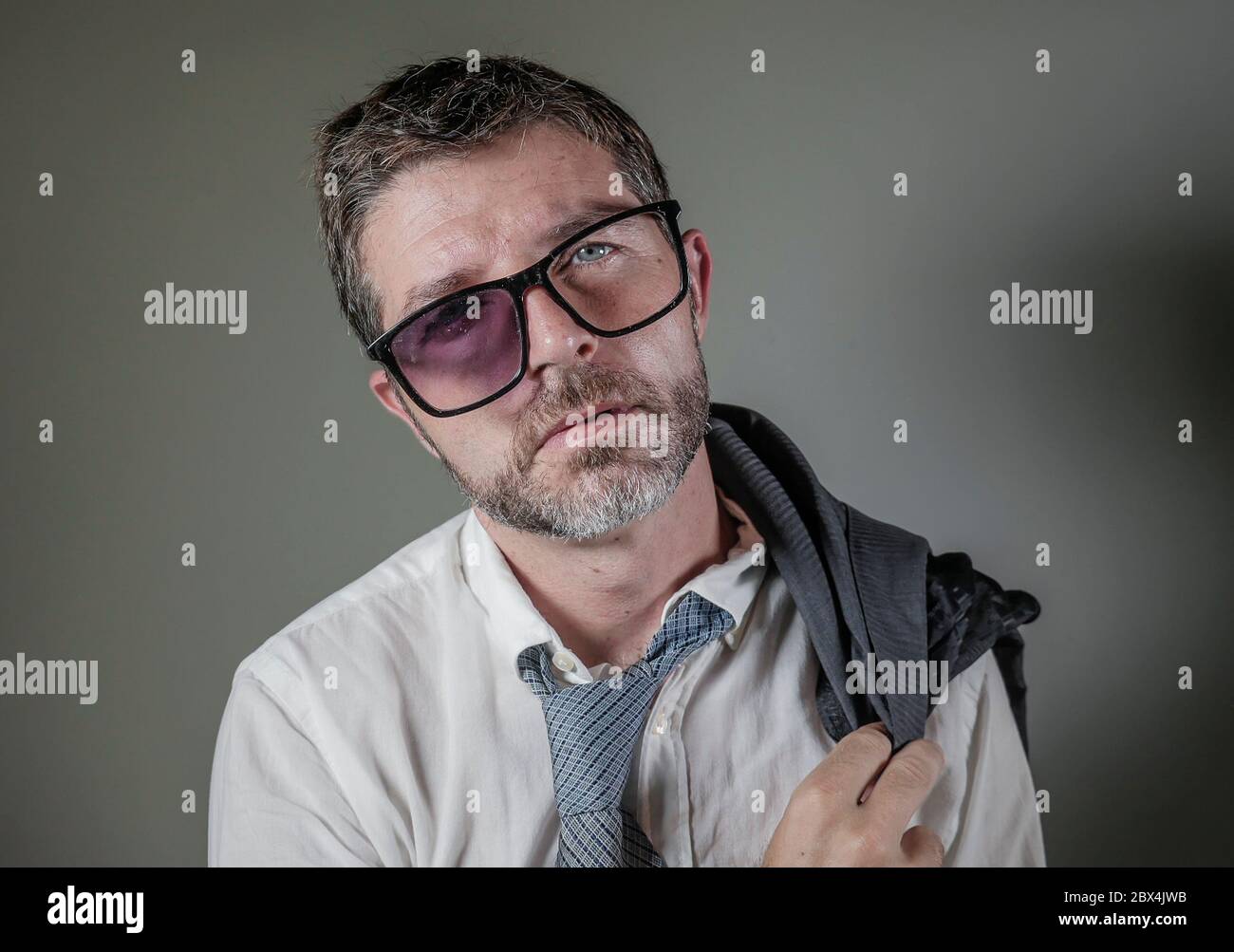 ritratto divertente di 40s strano e sprecato uomo d'affari in costume e  cravatta che indossa ridicolo grande vetri rotti nerdy posa esausto  sensazione di un perdente è Foto stock - Alamy