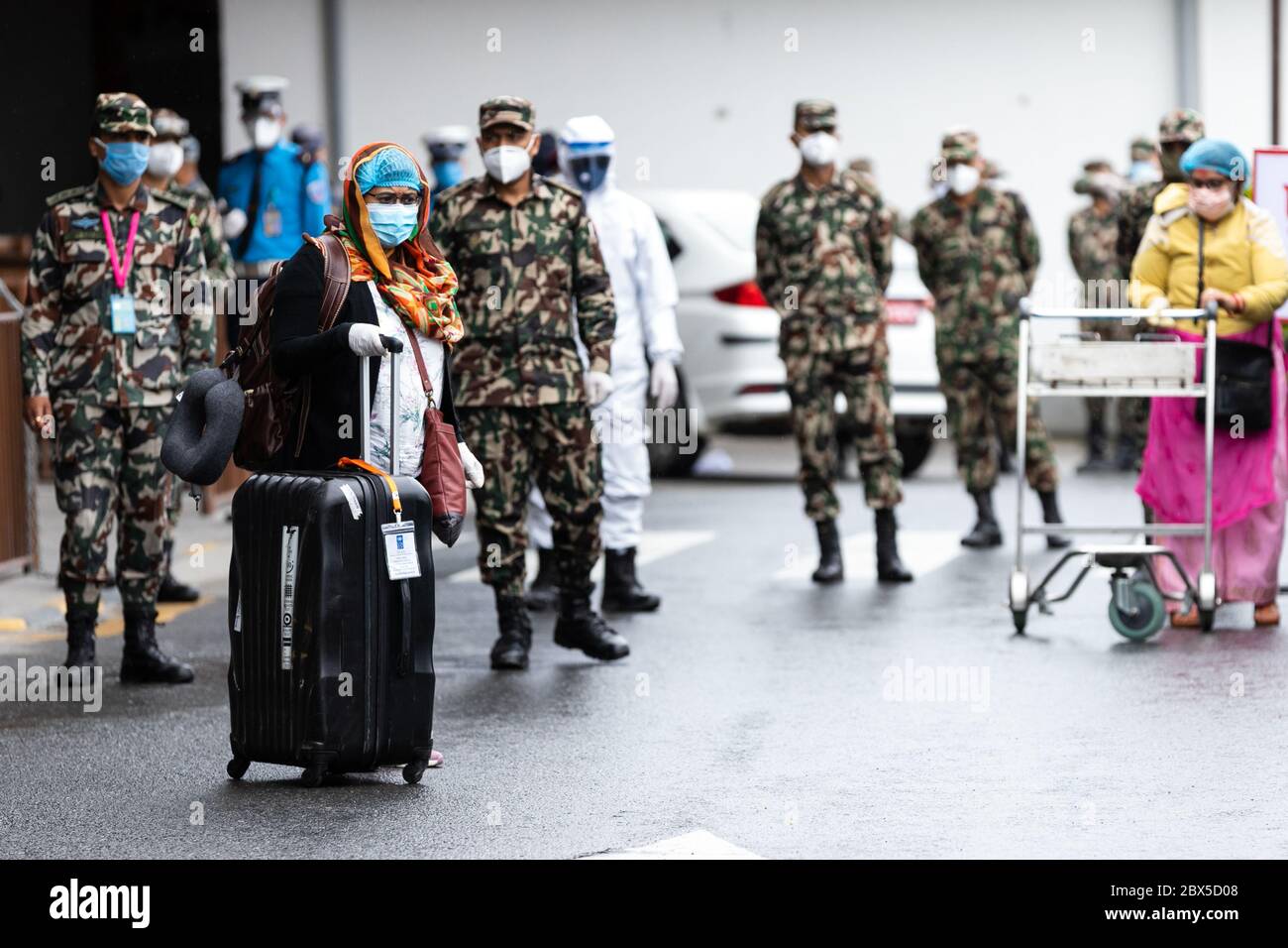 I cittadini nepalesi provenienti dal Myanmar che indossano maschere facciali come misura preventiva arrivano all'aeroporto internazionale di Tribhuvan tra le minacce di Coronavirus. I popoli nepalesi bloccati in Myanmar sono sbarcati attraverso una compagnia aerea militare del Myanmar. Il governo del Nepal ha iniziato a salvare le nazioni nepali bloccate in diversi paesi. Foto Stock