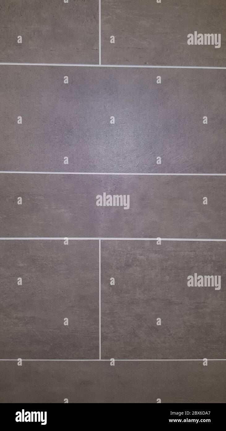 Struttura di fondo della piastrella del pavimento di grigio parete di cemento Foto Stock