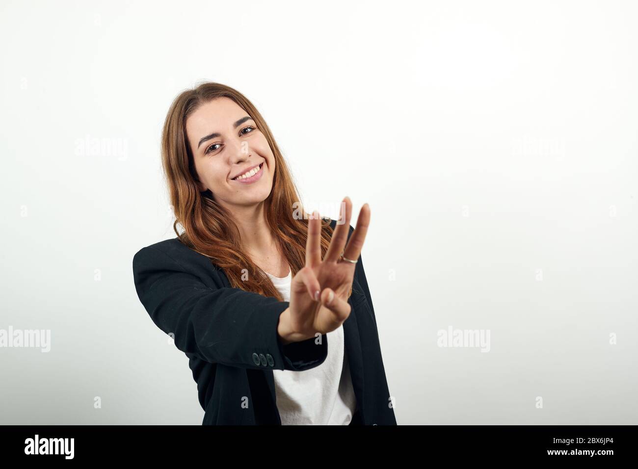 Happy femmina sorrisi mostra tre dita, account, business, dimostra Foto Stock