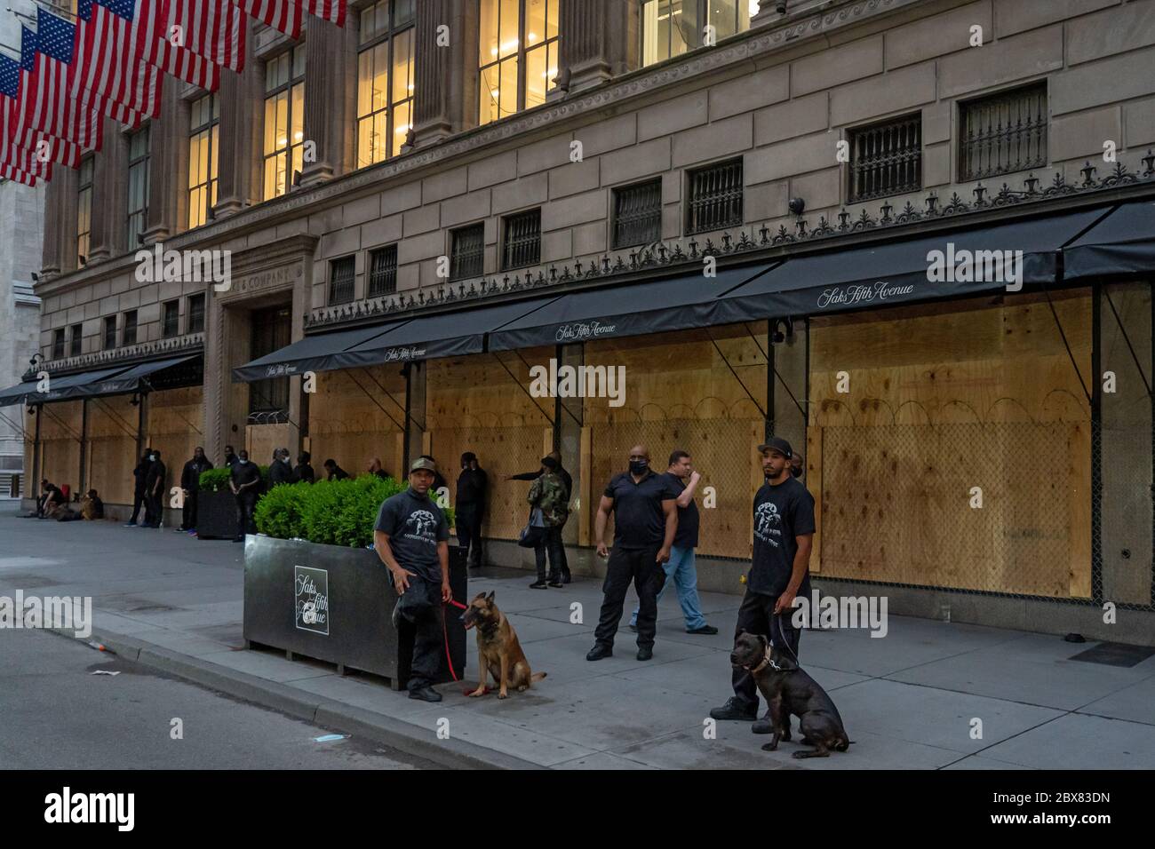 NEW YORK, NY - GIUGNO 03: La famosa Saks Fifth Avenue prepara per più saccheggio con la catena di collegamento recinzione sopra le finestre a bordo e le guardie di sicurezza e d Foto Stock