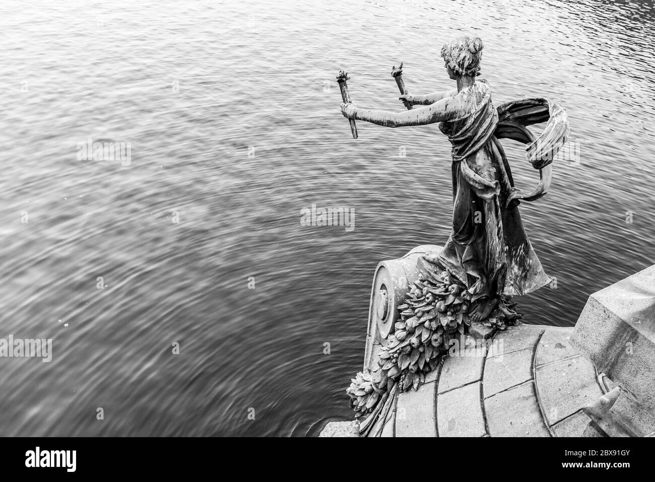 Figura donna portacolori - decorazione in bronzo del ponte di Svatopluk sul fiume Moldava a Praga, Repubblica Ceca. Immagine in bianco e nero. Foto Stock