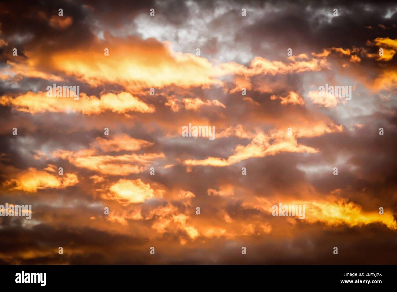 Paesaggio nuvoloso con un tramonto glorioso e suggestivo, con nuvole scure aggiunte al mix Foto Stock