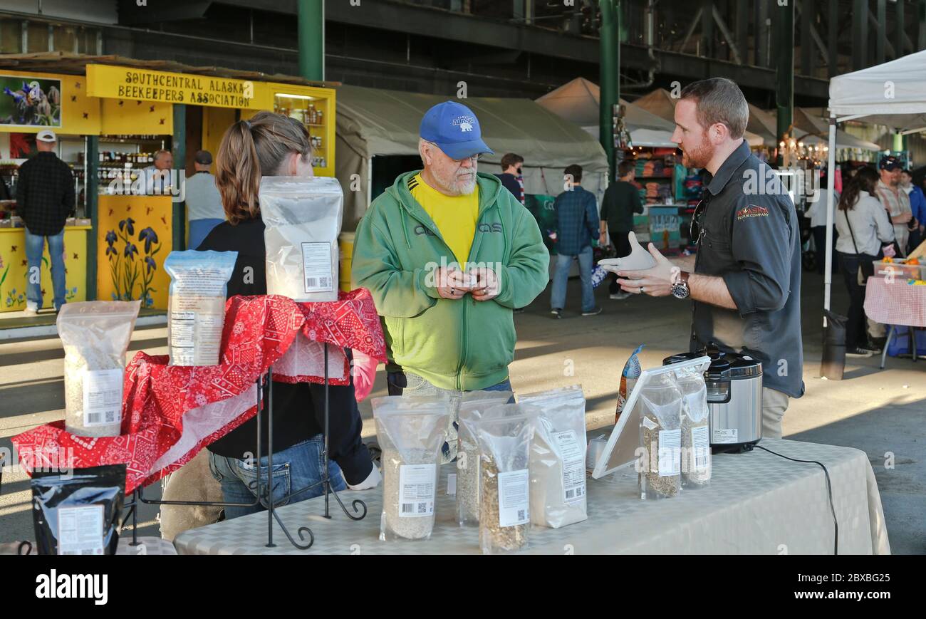 Rappresentante di Alaska Flour Mill Co. Comunicando con i clienti senior interessati per quanto riguarda i loro prodotti di orzo. Foto Stock