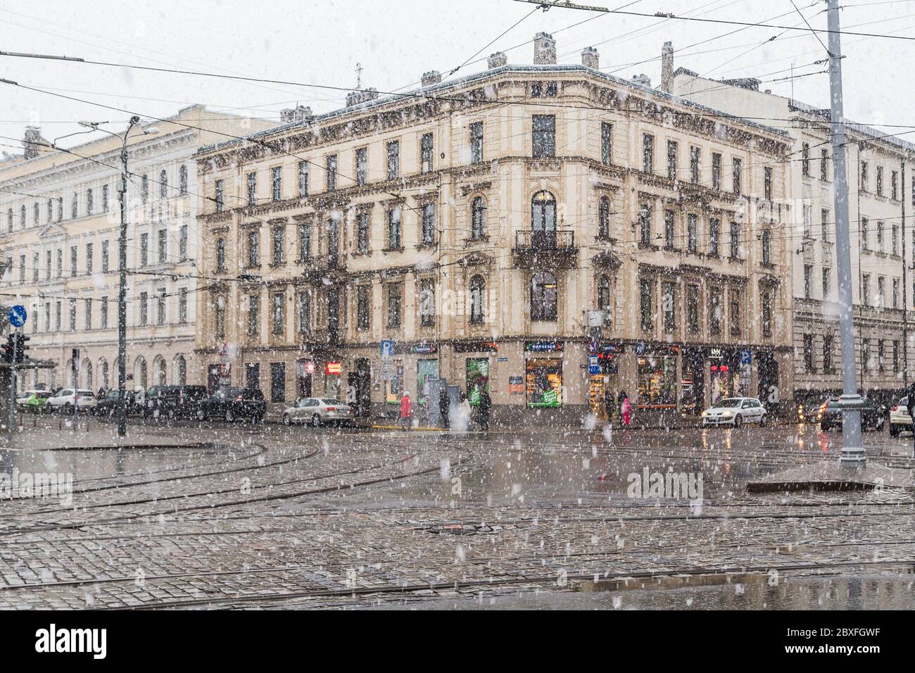 RIGA, LETTONIA - 2 GENNAIO 2017: Neve pesante che cade nel centro di riga durante il giorno in inverno. Edifici, veicoli e persone possono essere visti. Foto Stock