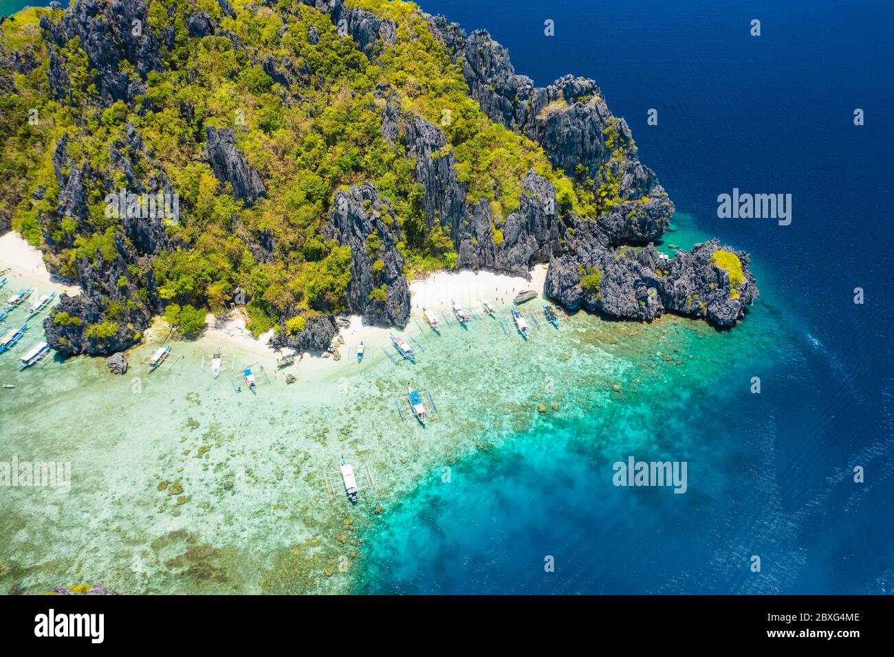 Isola di Shimizu, El Nido, Palawan, Filippine. Splendida vista aerea dell'isola tropicale, della spiaggia sabbiosa, della barriera corallina e delle scogliere calcaree Foto Stock