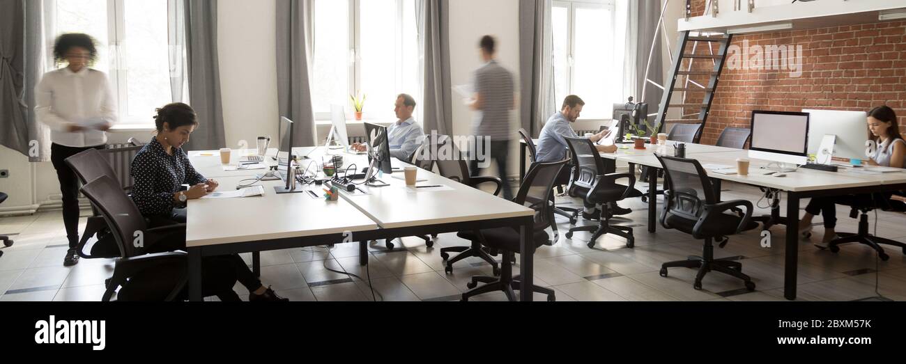 Gruppo di dipendenti multietnici che lavorano in spazi aperti di cooperazione Foto Stock