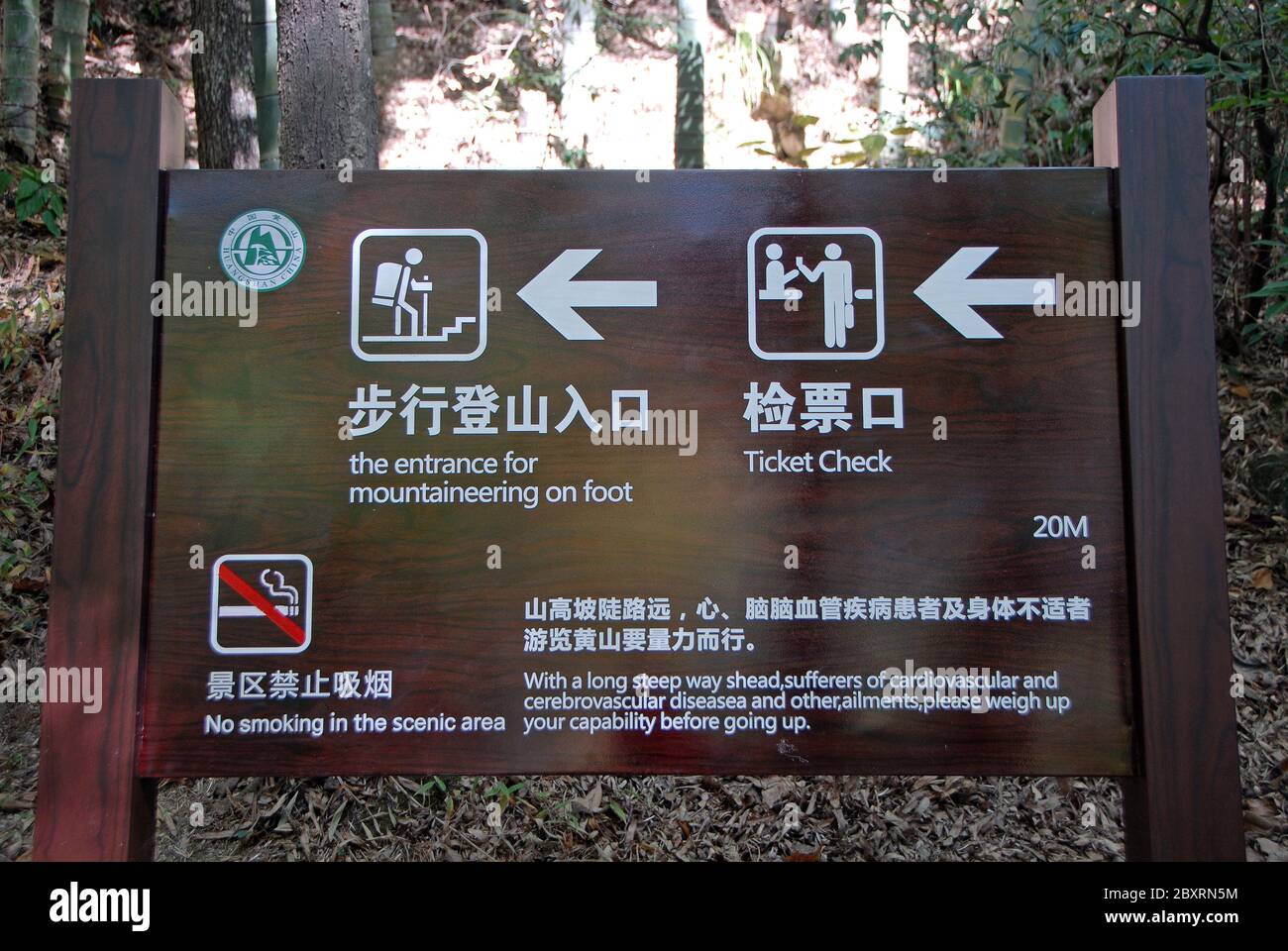 Monte Huangshan nella provincia di Anhui, Cina. Cartello vicino al Mercy Light Pavilion alla base di Huangshan che fornisce indicazioni per camminare lungo il sentiero occidentale Foto Stock