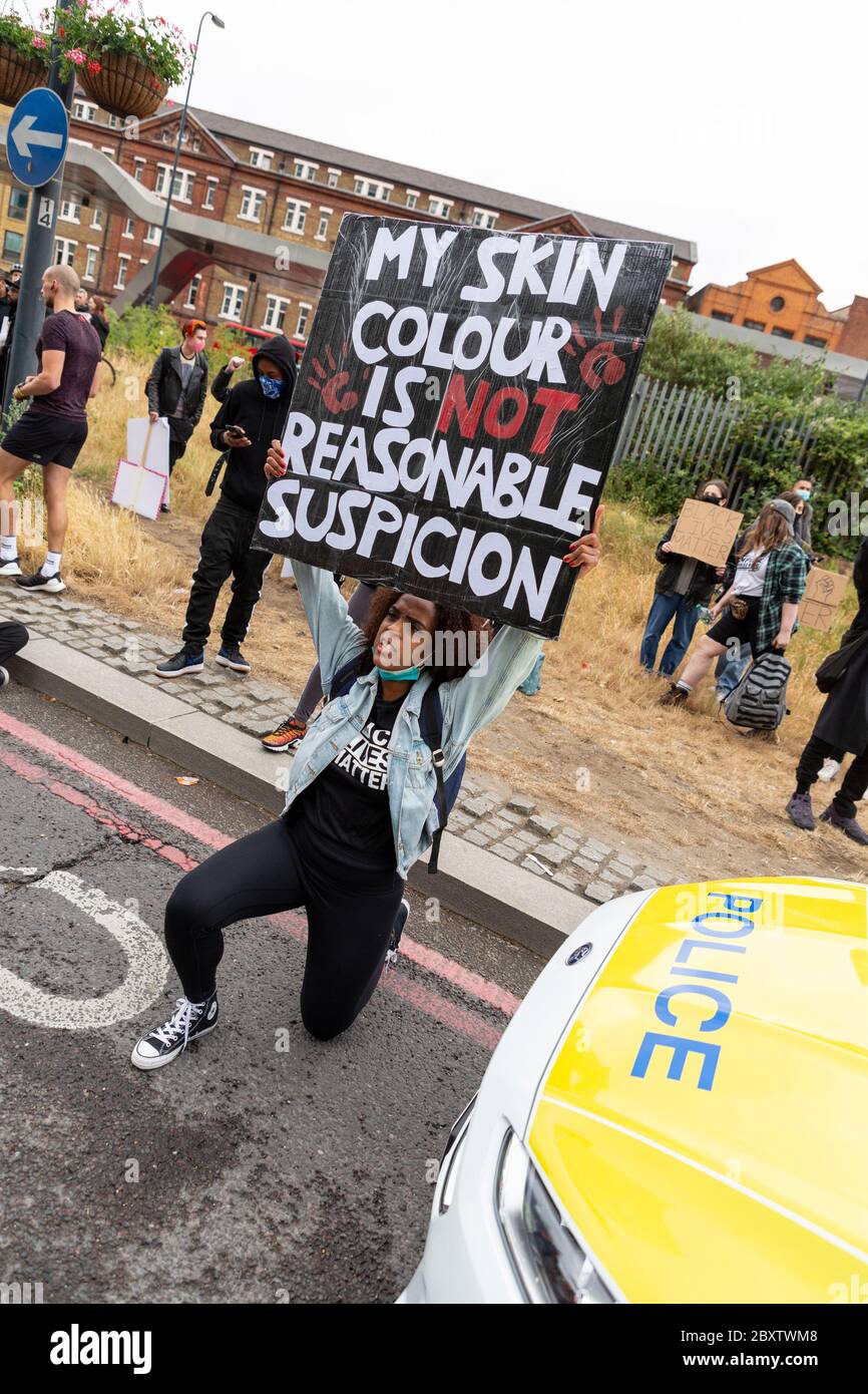 Una donna nera si inginocchiò davanti a una macchina di polizia e tiene un cartello durante la protesta Black Lives Matters a Londra, 6 giugno 2020 Foto Stock Una donna nera si inginocchiò davanti a una macchina di polizia e tiene un cartello durante la protesta Black Lives Matters a Londra, 6 giugno 2020 Foto Stock