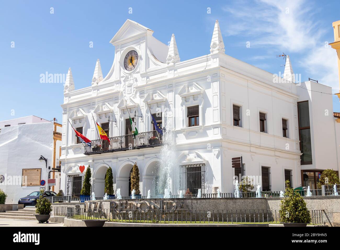 Vista della facciata bianca del Municipio di Cartaya nella provincia di Huelva, Andalusia, Spagna. Il testo 'Plaza Redonda' significa quadrato rotondo Foto Stock