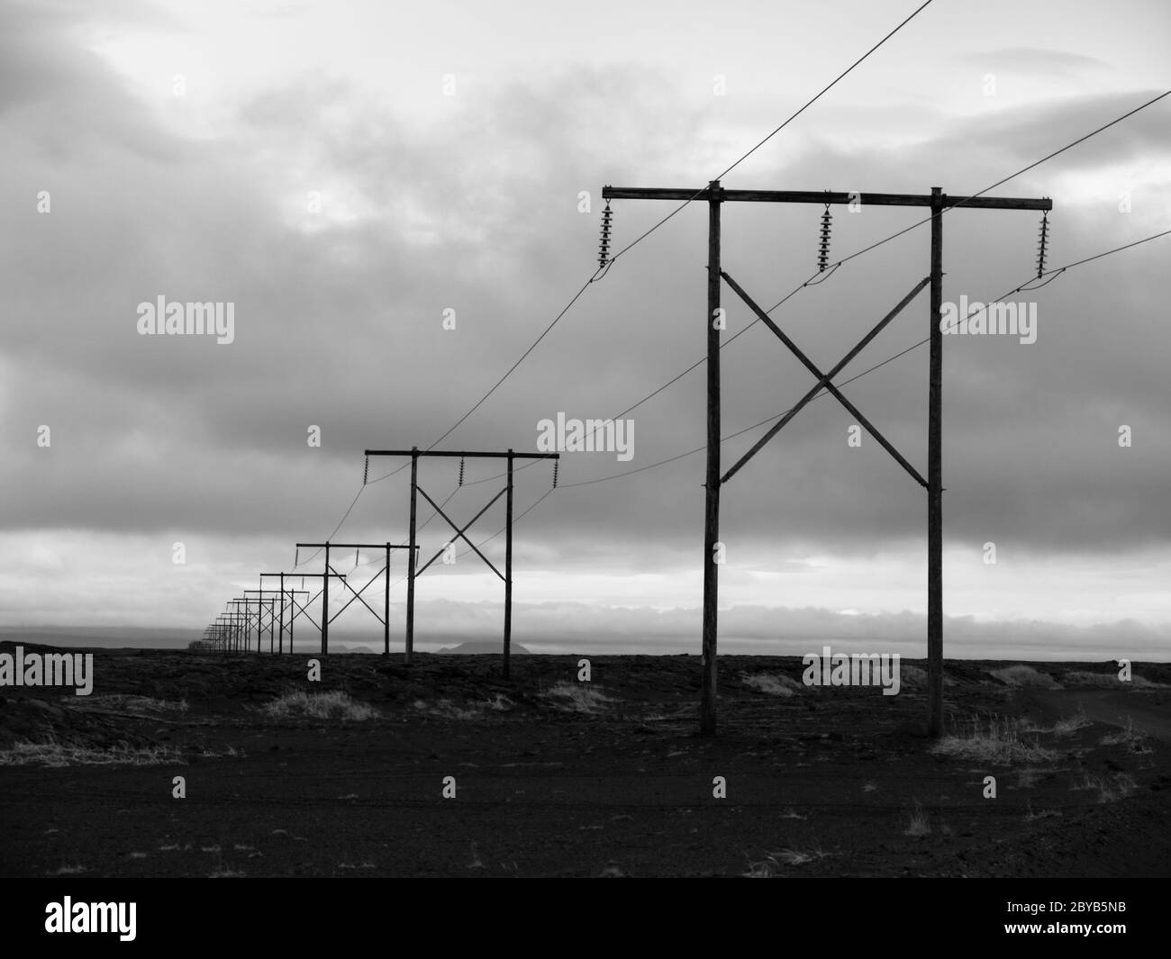Paesaggio islandese con linee elettriche tipiche, immagine in bianco e nero Foto Stock