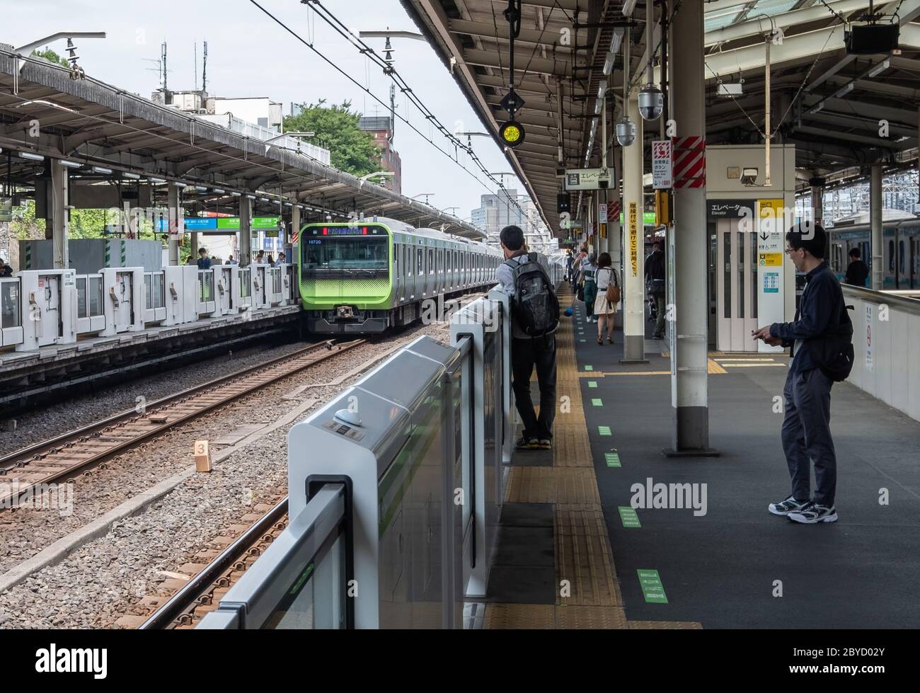 Japan Railway linea ferroviaria Yamanote in arrivo alla piattaforma della stazione di Harajuku, Tokyo, Giappone. Foto Stock