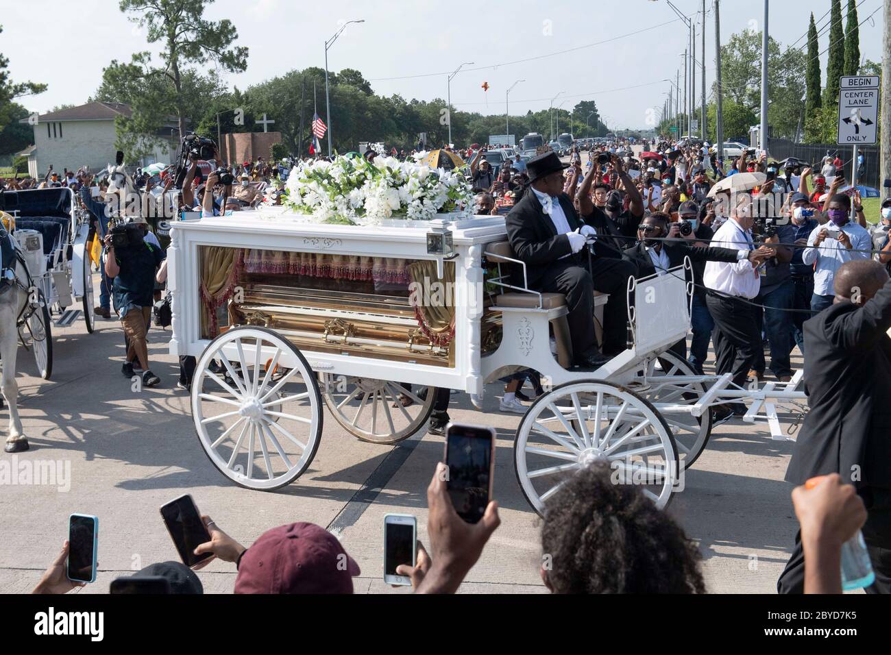 Una carrozza trainata da cavalli contenente il corpo di George Floyd si avvicina al cimitero dei Memorial Gardens di Houston, nella periferia di Houston, dove sarà sepolto accanto alla madre. La morte di Floyd, ucciso a fine maggio da un poliziotto bianco, ha scatenato proteste in tutto il mondo contro il razzismo e la brutalità della polizia. Foto Stock