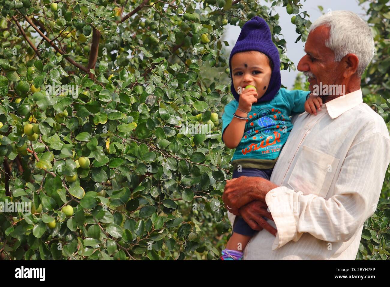 6 marzo 2020. Felice bambino e grande padre di mezza età in piedi nel giardino rajasthan, india Foto Stock