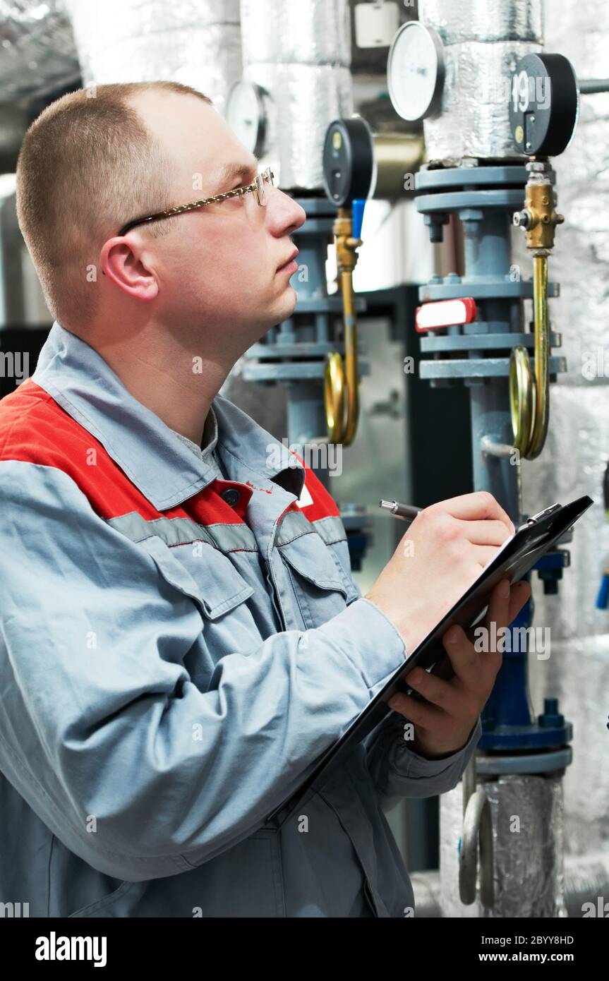 ingegnere del riscaldamento in locale caldaia Foto Stock