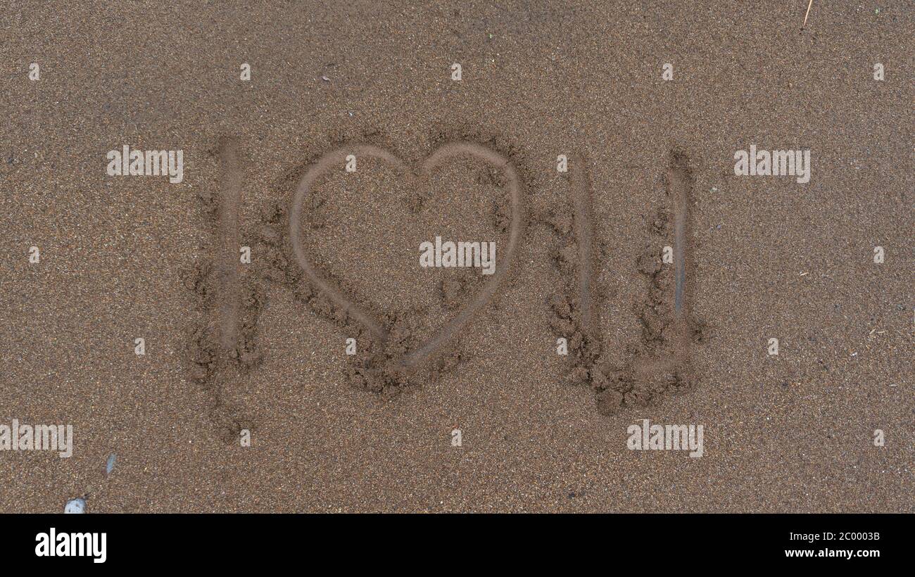 Le parole 'ti amo' sulla sabbia, espressione di amore per il mio caro Foto Stock