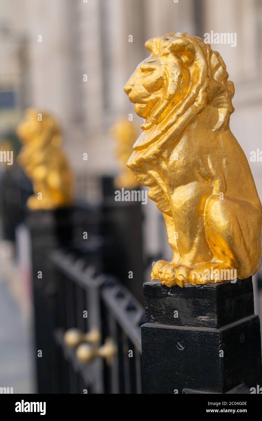 Leoni dorati dorati seduti sulla cima delle ringhiere metalliche fuori della Law Society a Chancery Lane, Londra, Inghilterra - 2 Foto Stock