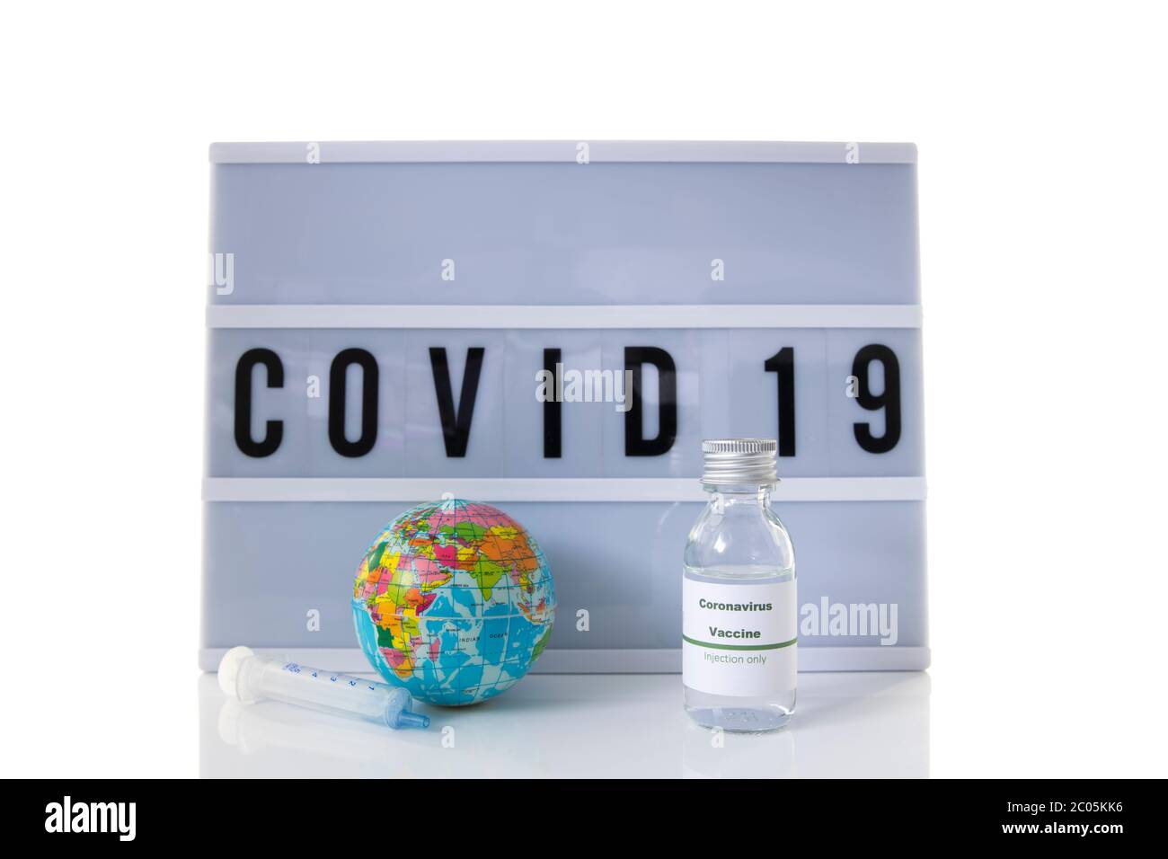 covid 19 su display di testo con sfondo bianco e globo mondiale e vaccino Foto Stock