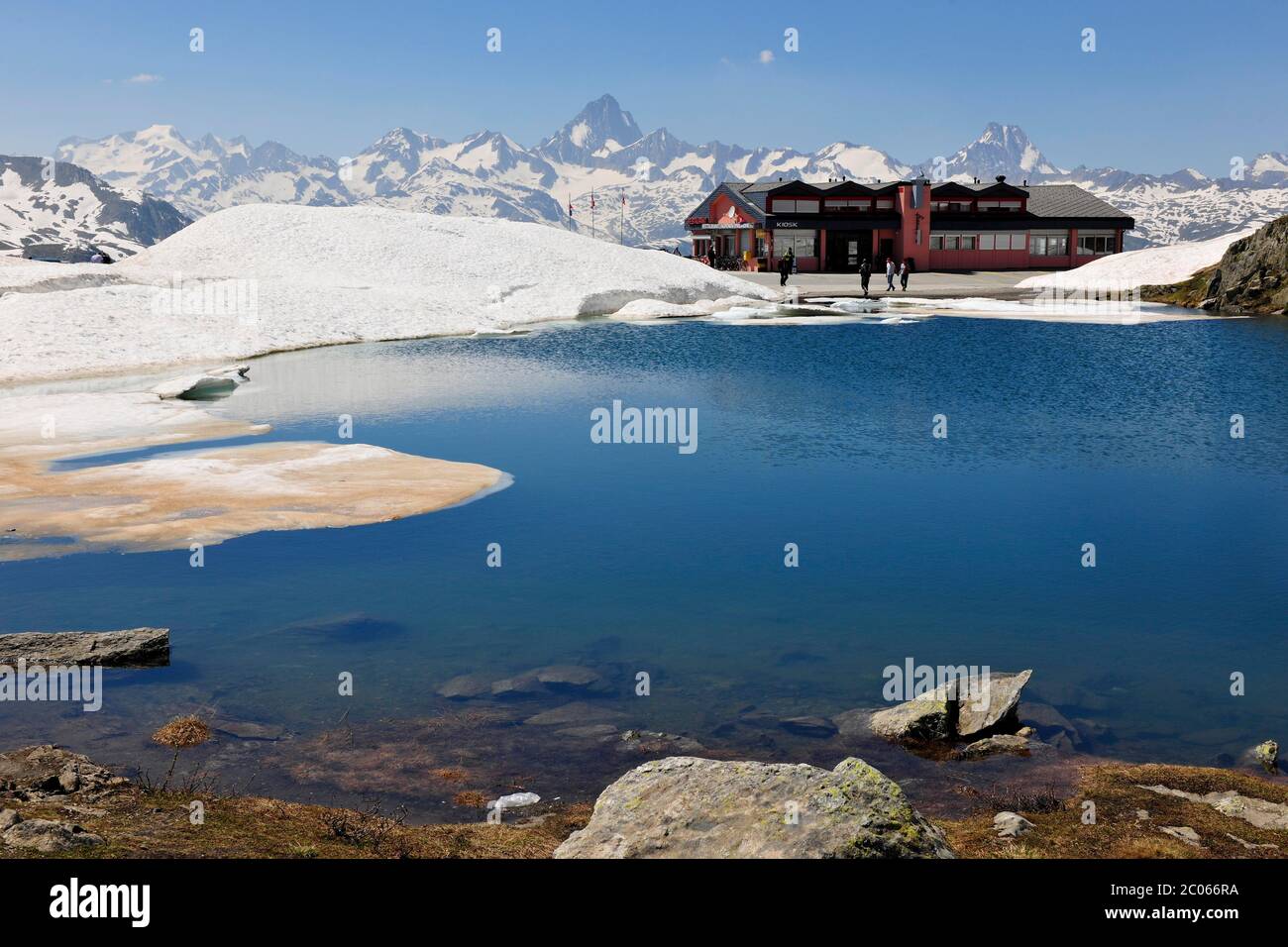 Passa il Passo Nufenenpass con ristorante, piccolo lago di montagna, cime innevate Passo Nufenenpass con neve, ristorante e piccolo lago di montagna Foto Stock