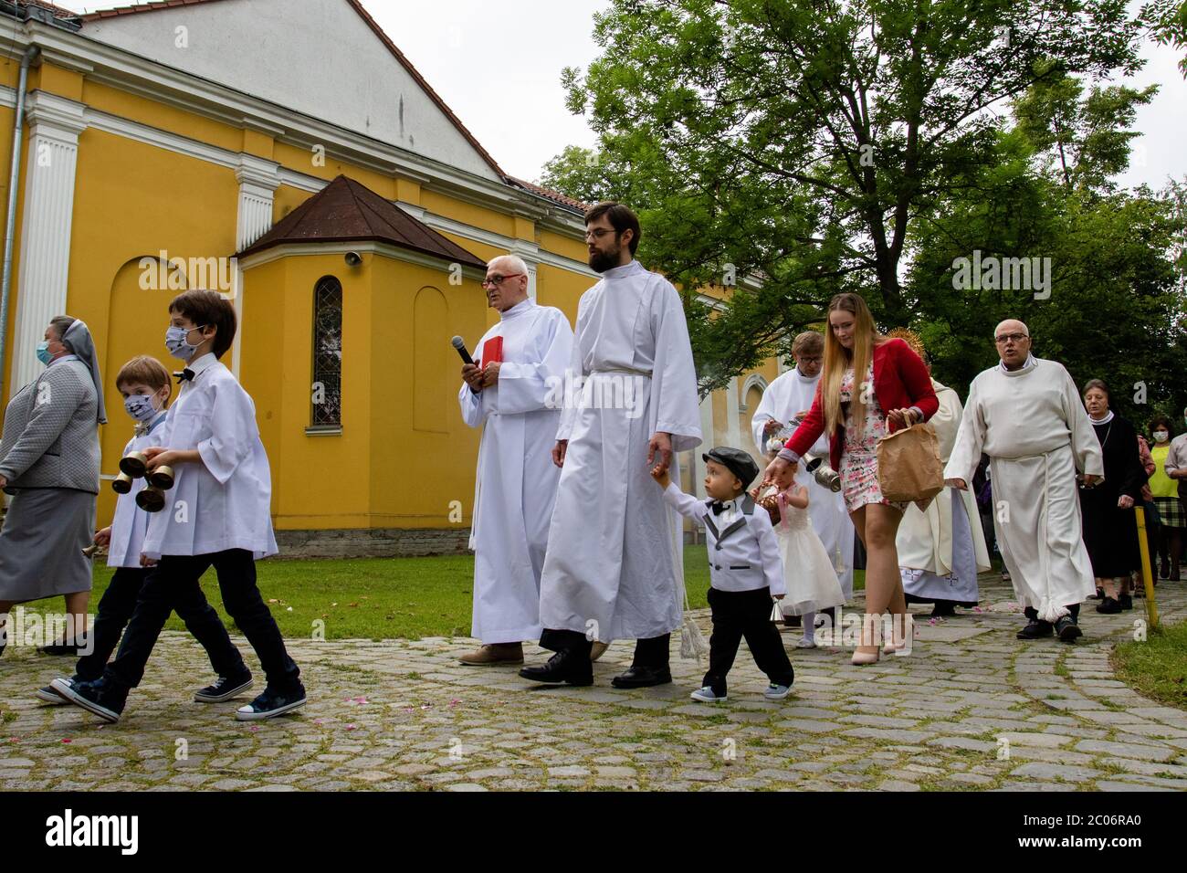 Albanesi che indossano maschere alla parrocchia della Beata Vergine Maria di Czestochowa, in via Kochanowskiego, durante la processione.Festa del corpo e del sangue di Cristo (Corpus Christi) È una festa dedicata alla venerazione del corpo e del sangue di Cristo, in cui il pane e il vino si trasformano durante l'Eucaristia secondo la fede cristiana. Secondo la tradizione, in questo giorno si organizza una solenne processione per le strade della Chiesa cattolica. In Polonia, questo giorno è una festa pubblica. Quest'anno, molti partecipanti alla processione indossavano maschere mediche, tra cui l'alt Foto Stock