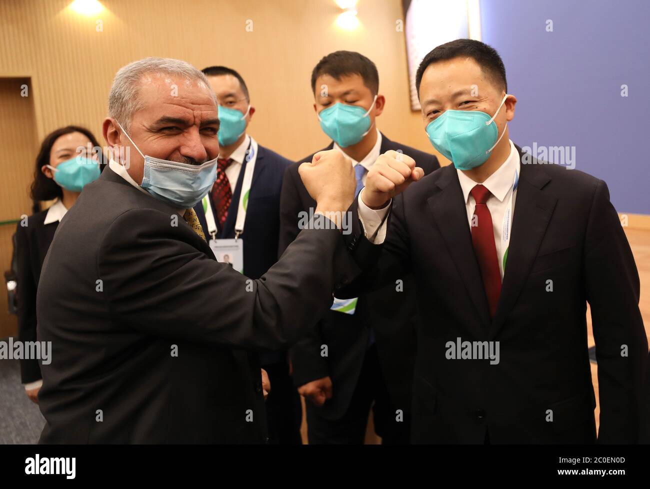 (200612) -- RAMALLAH, 12 giugno 2020 (Xinhua) -- il primo ministro palestinese Mohammad Ishtaye (L, anteriore) saluta il team di esperti medici cinesi nella città di Ramallah, in Cisgiordania, 11 giugno 2020. Un team di esperti medici cinesi, che è arrivato in Palestina mercoledì, è stato messo insieme dalla Commissione Nazionale della Sanità della Cina con i membri selezionati dalla Commissione Municipale della Sanità di Chongqing. Il team è composto da esperti di vari settori, come le malattie respiratorie e infettive, la medicina tradizionale cinese, epidemiologia e infermieristica. Hanno previsto di tenere una serie di riunioni e di v Foto Stock