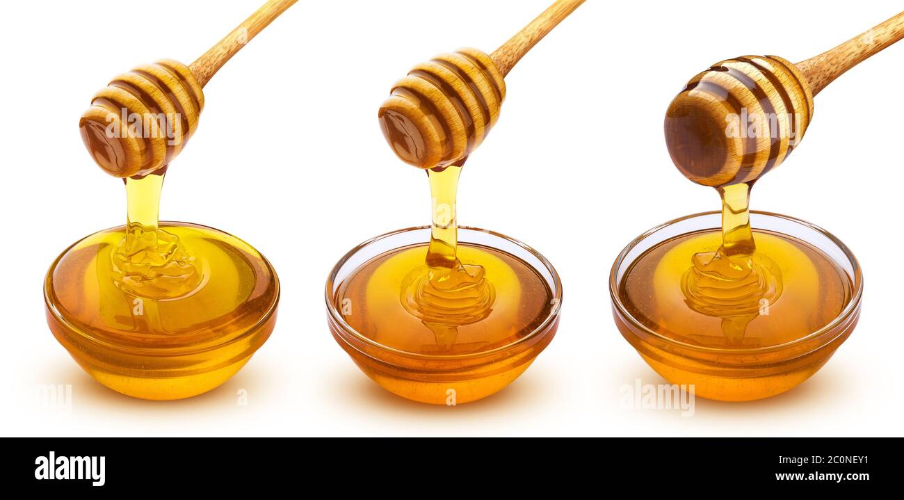 La bacchetta di miele e una ciotola di colata di miele isolati su sfondo bianco Foto Stock