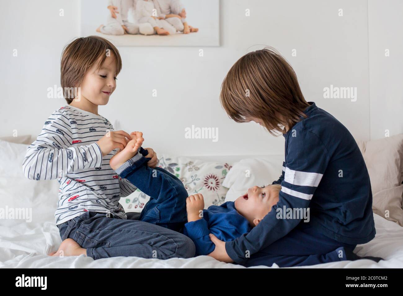 Bambini, fratelli, giocare a casa, piedi solletico ridendo e sorridendo Foto Stock