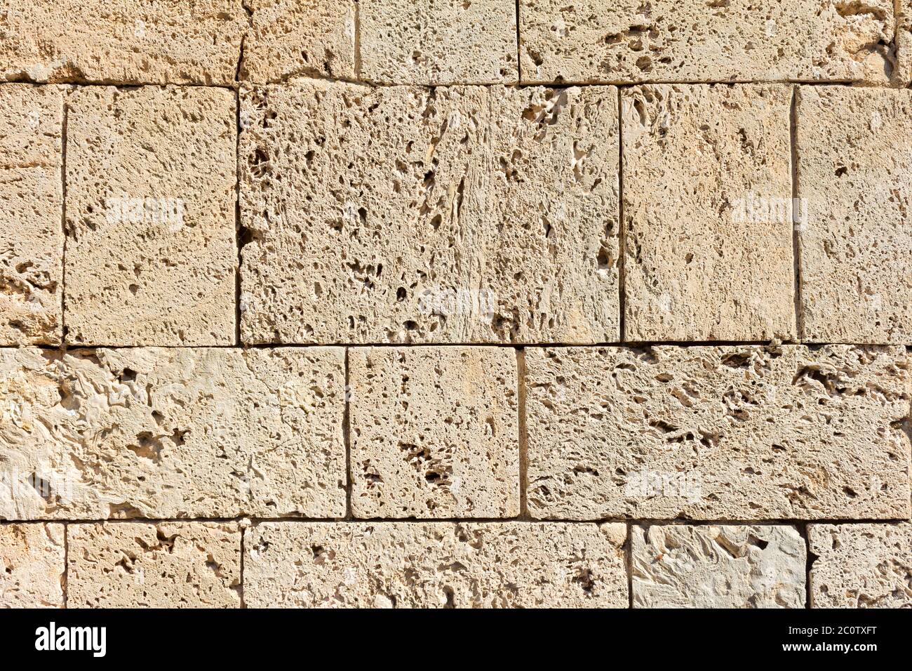 Muro di mattoni di arenaria su texture sole Foto Stock