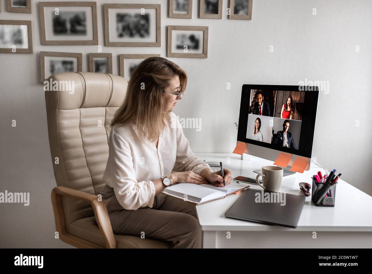 Videoconferenza. Il manager tiene una riunione aziendale su un computer da casa Foto Stock