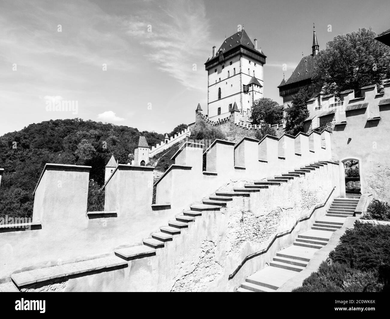 Castello reale di Karlstejn, castello gotico medievale con mura di fortificazione in estate soleggiato giorno. Repubblica Ceca. Immagine in bianco e nero. Foto Stock