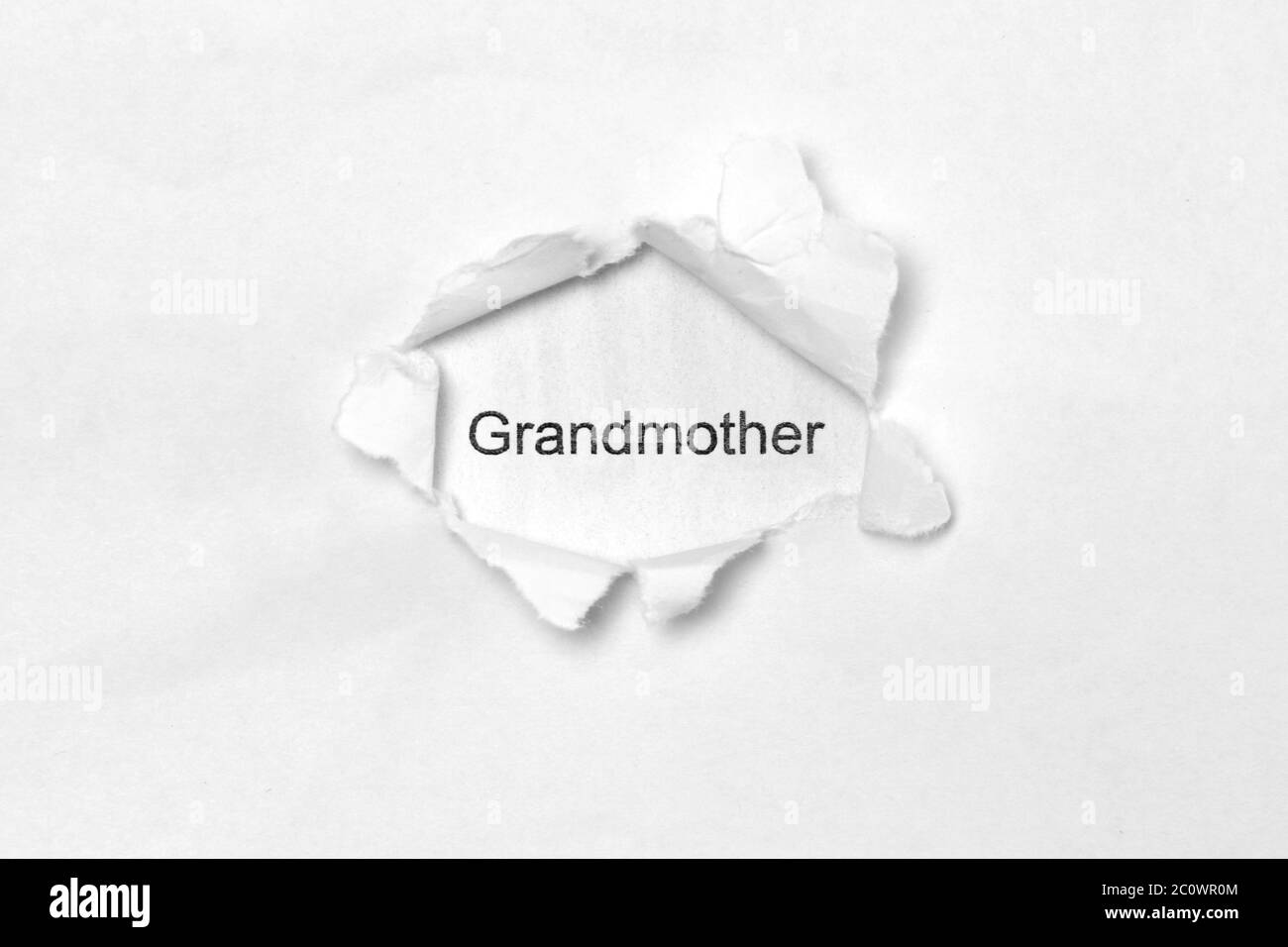Nonna di parola su sfondo bianco isolato, l'iscrizione attraverso il foro della ferita in carta. Foto a magazzino per il Web e stampa con spazio vuoto per il testo Foto Stock