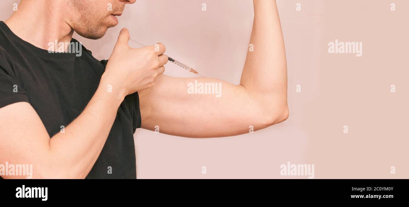 L'uomo inietta l'ormone steroide. Procedura di iniezione della crescita Foto Stock