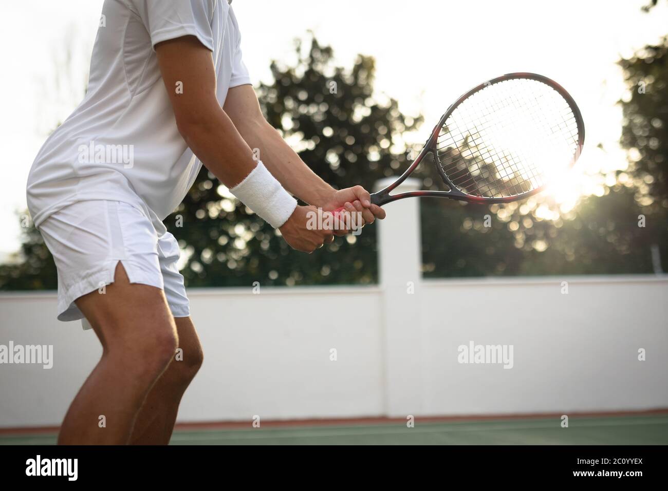 Allenamento di un uomo caucasico su un campo da tennis Foto Stock