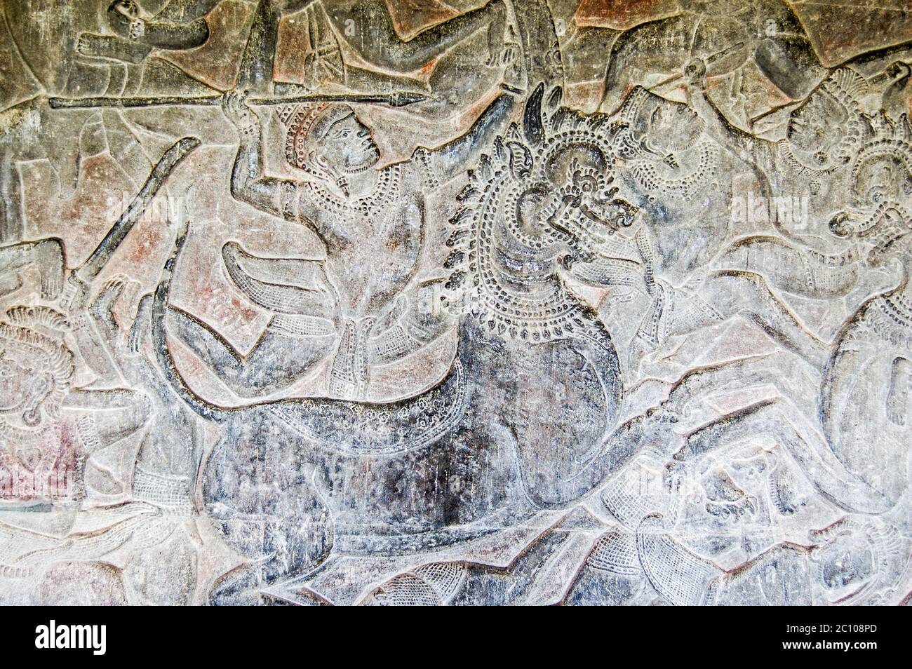 Antica scultura Khmer di un dio indù che si batte in battaglia sul dorso di un leone imperiale. Bas sollievo fregio su un muro di Angkor Wat Tempio, Siem Reap, Foto Stock