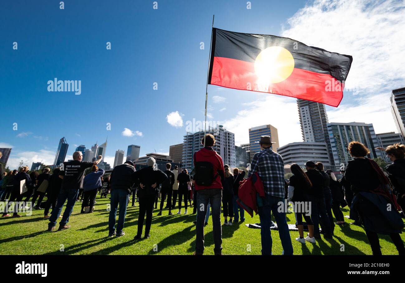 Perth, Australia. 13 giugno 2020. I manifestanti di un raduno Black Lives Matter in mostra la bandiera aborigena australiana. Credit: Steve Worner/Alamy Live News Foto Stock