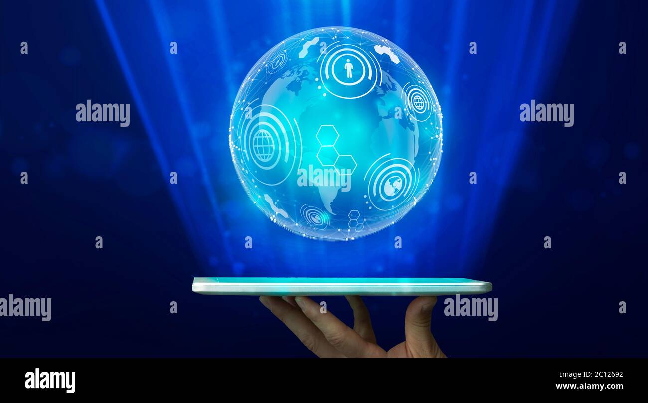 Mano che tiene il tablet e globo olografico su sfondo blu, Panorama Foto Stock