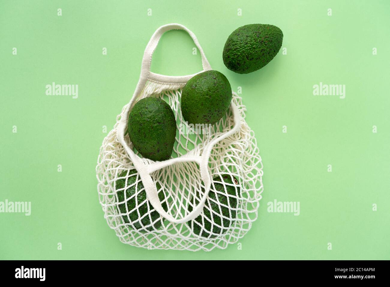 Borsa di cotone eco mesh della drogheria con avocados.Vegetarianism. Concetto di shopping e stile di vita salutare eco-friendly. Foto Stock