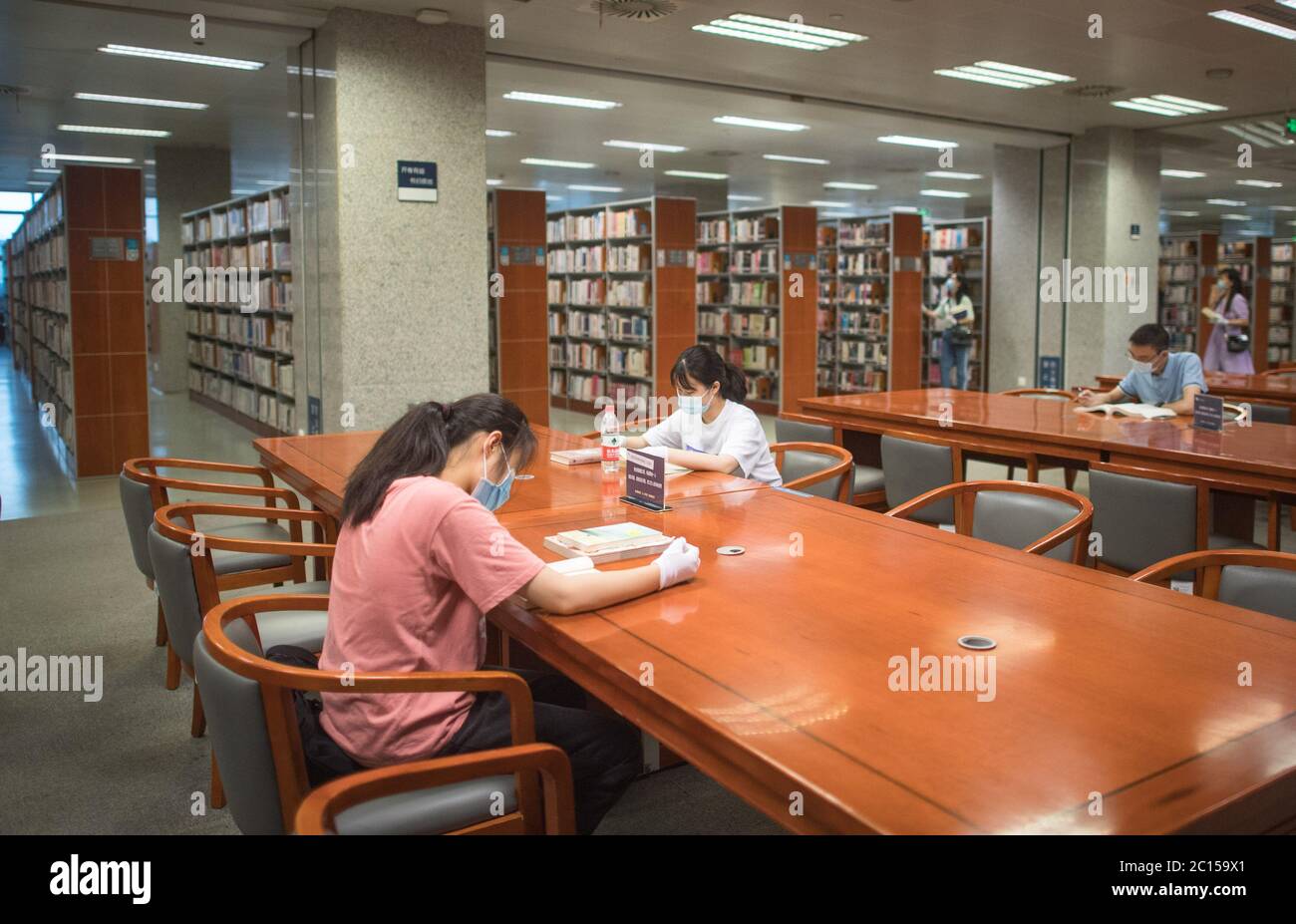 (200614) -- WUHAN, 14 giugno 2020 (Xinhua) -- persone che leggono a distanza l'una dall'altra presso la Biblioteca Provinciale Hubei di Wuhan, capitale della provincia di Hubei, in Cina centrale, 14 giugno 2020. La provincia cinese di Hubei, una volta duramente colpita dal COVID-19, domenica ha riaperto cinque importanti luoghi culturali pubblici nell'ultima mossa per tornare alla normalità dopo che l'epidemia si è ridotta. I luoghi di ritrovo includono il museo provinciale, la biblioteca provinciale, la sala commemorativa della rivoluzione Xinhai, il museo d'arte provinciale e il centro d'arte di massa, tutti situati nella capitale provinciale Wuhan. Tutte e cinque le strutture Foto Stock