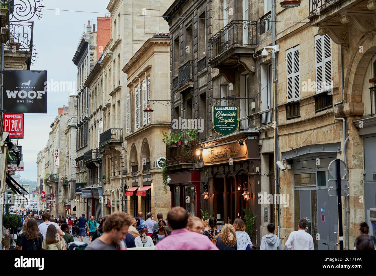 Acquisti sulla Rue Saint Remi, una strada commerciale con un chiosco di hot dog, un ristorante di pizza e un negozio di champagne, Bordeaux, Francia Foto Stock